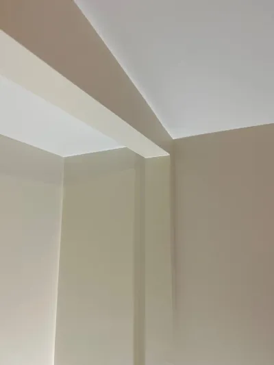 Close-up of a ceiling soffit with concealed LED lighting casting a soft glow along the corner.